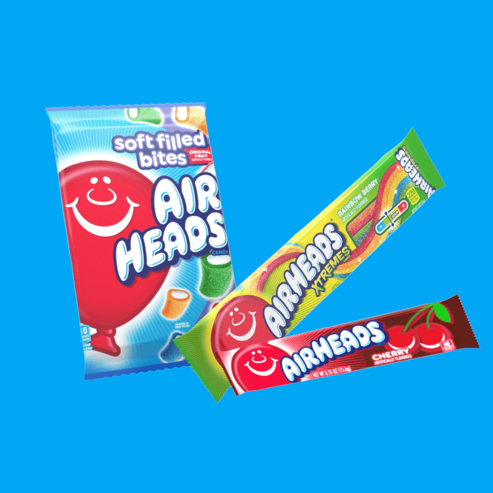 A 10 piece package of Airheads Soft Filled Bites next to a package of Airheads Extremes Rainbow Berry and an Airheads cherry flavored bar.